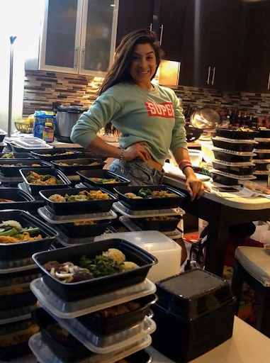 Latina woman with lots of meal prep in her kitchen